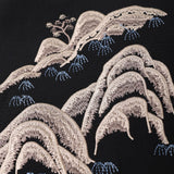 The KIKI and JOJO Kids Suit Jacket – Black (3-14 Years) features beige embroidered hills with blue accents and a small tree on wrinkle-free fabric; a stylish, slim-fit option for kids.