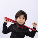 A young boy models the KIKI and JOJO Kids Dress Shirt – Black Long Sleeve (3-14 Years), classic fit, with a red bow tie and bat, making a stylish statement against a plain white background.