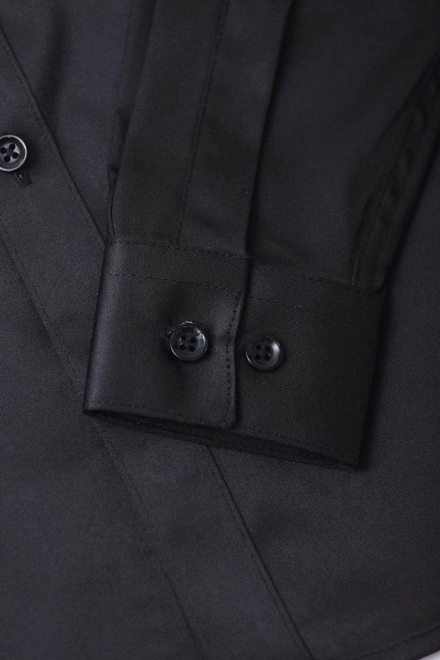 Close-up of the KIKI and JOJO Kids Dress Shirt – Black Long Sleeve (3-14 Years) – Classic Fit, highlighting the sleeve cuff with two black buttons and front buttons for a timeless look.