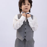 A young boy wearing the KIKI and JOJO Kids Dress Shirt – White Long Sleeve (Classic Fit, ages 3-14) stands against a light background, offering timeless style inspiration for both boys’ and girls’ dress shirts.
