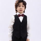 A young boy with tousled hair wears a white shirt, black pinstripe vest and pants, and a KIKI and JOJO Kids Bow Tie – Burgundy Bear (pre-tied satin, adjustable), standing against a plain light background.