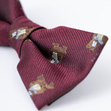 A close-up of the KIKI and JOJO Kids Bow Tie – Burgundy Bear – Pre-Tied Satin, featuring embroidered bears, shown on a white background.