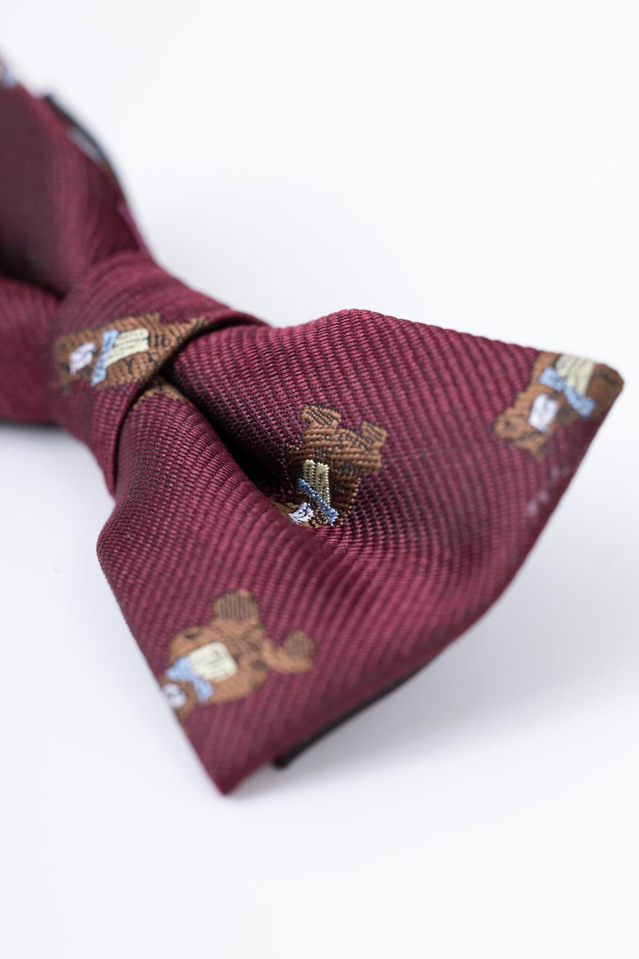 A close-up of the KIKI and JOJO Kids Bow Tie – Burgundy Bear – Pre-Tied Satin, featuring embroidered bears, shown on a white background.