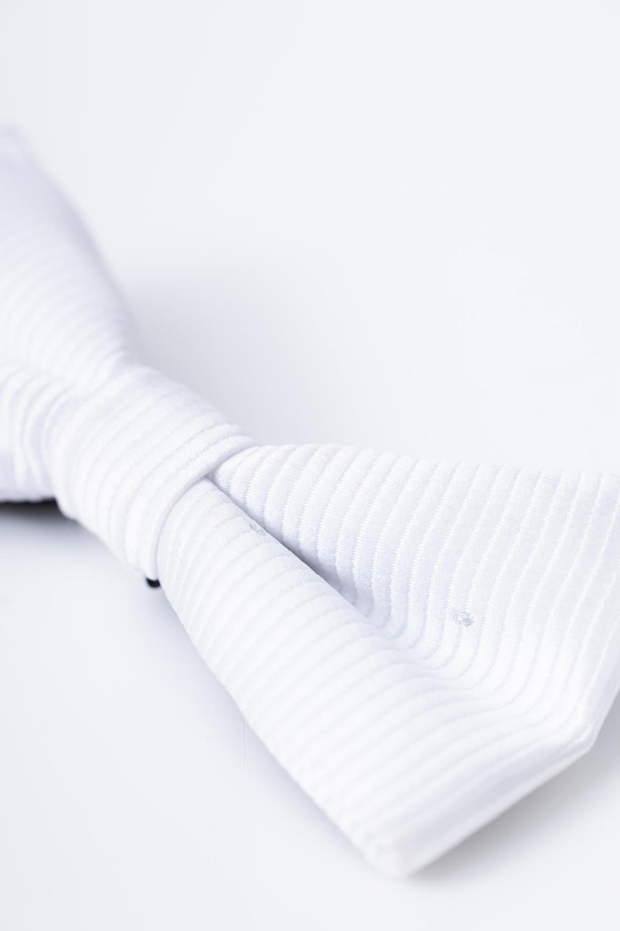Close-up of the KIKI and JOJO Kids Bow Tie – White & Black, a pre-tied satin accessory with an adjustable fit, shown against a plain white background for a timeless style.