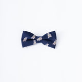 The KIKI and JOJO Kids Bow Tie – Navy Blue Bear features a cute bear pattern, is pre-tied, made from premium satin, and adjustable. Displayed on a plain white background, it's perfect for any stylish child.