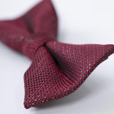 A close-up of the KIKI and JOJO Kids Bow Tie – Burgundy & Black, a pre-tied adjustable satin accessory, shown on a white surface.