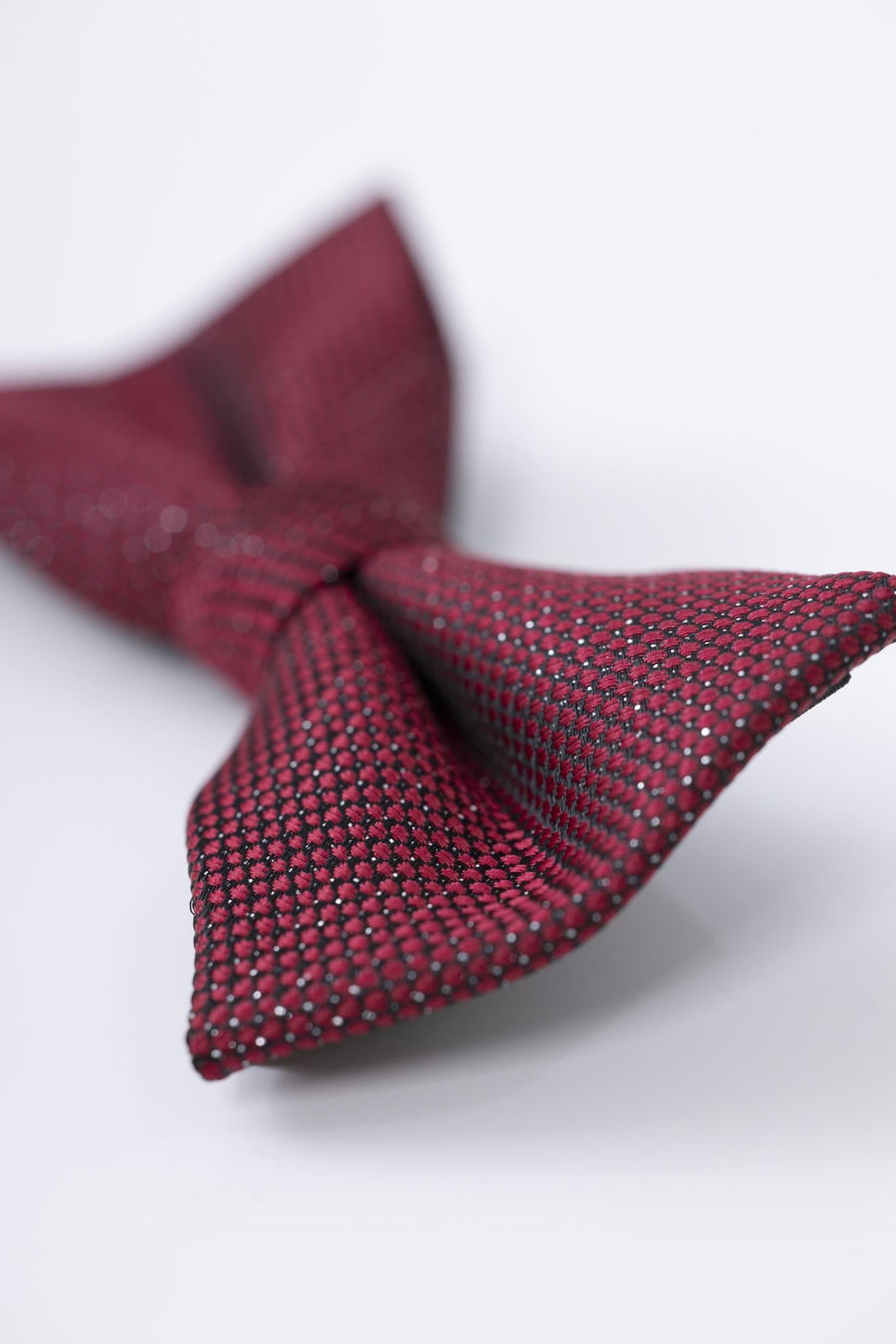 A close-up of the KIKI and JOJO Kids Bow Tie – Burgundy & Black, a pre-tied adjustable satin accessory, shown on a white surface.