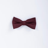 The KIKI and JOJO Kids Bow Tie in burgundy & black satin, pre-tied and adjustable, is displayed against a plain white background.