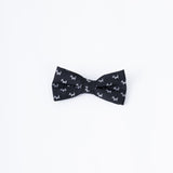 The KIKI and JOJO Kids Bow Tie – Black Puppy features a pre-tied, adjustable satin design with a charming white puppy pattern, shown on a plain white background.