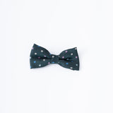 The KIKI and JOJO Kids Bow Tie – Green – Pre-Tied Satin – Adjustable features a dark forest green shade with small white and pink squares, displayed on a plain white background.