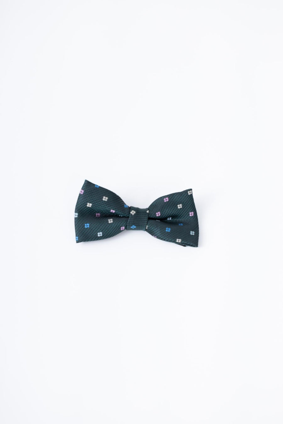 The KIKI and JOJO Kids Bow Tie – Green – Pre-Tied Satin – Adjustable features a dark forest green shade with small white and pink squares, displayed on a plain white background.