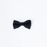 The KIKI and JOJO Kids Bow Tie in black, a pre-tied satin accessory with an adjustable fit, is centered on a plain white background—ideal for complementing kids dress shirts or tailored suits.