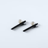 KIKI and JOJO’s Girls Pearl Hair Clips – Set of Two – Black Velvet are displayed on a plain light background, each clip featuring a single pearl embellishment.