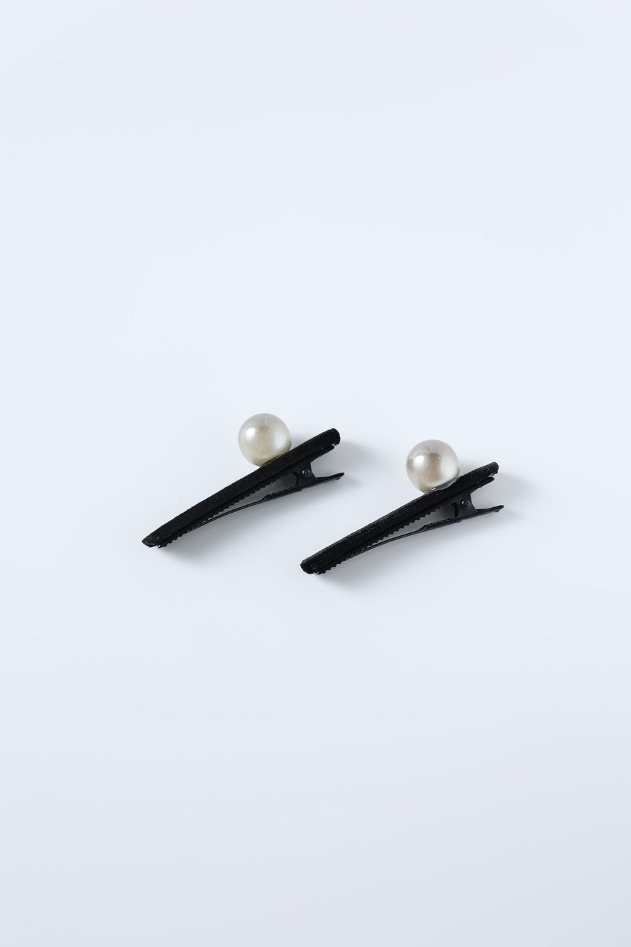 KIKI and JOJO’s Girls Pearl Hair Clips – Set of Two – Black Velvet are displayed on a plain light background, each clip featuring a single pearl embellishment.