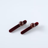 Set of 2 Girls Pearl Hair Clips by KIKI and JOJO, crafted from burgundy velvet with a velvety texture and glossy round brown beads, displayed on a plain light background.