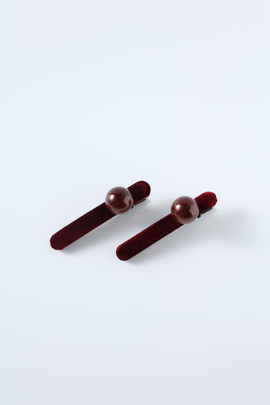 Set of 2 Girls Pearl Hair Clips by KIKI and JOJO, crafted from burgundy velvet with a velvety texture and glossy round brown beads, displayed on a plain light background.