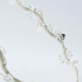 A close-up of the KIKI and JOJO Beaded Flower Girl Headband, featuring gold wire-wrapped branches with translucent crystal-like beads resembling delicate flowers, set against a light background.