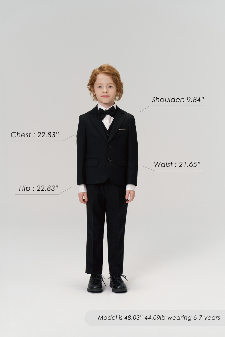 A young boy models the Noir Bloom Suit Vest by KIKI and JOJO against a white background, with his measurements and size details shown—ideal for refreshing his formal wardrobe.