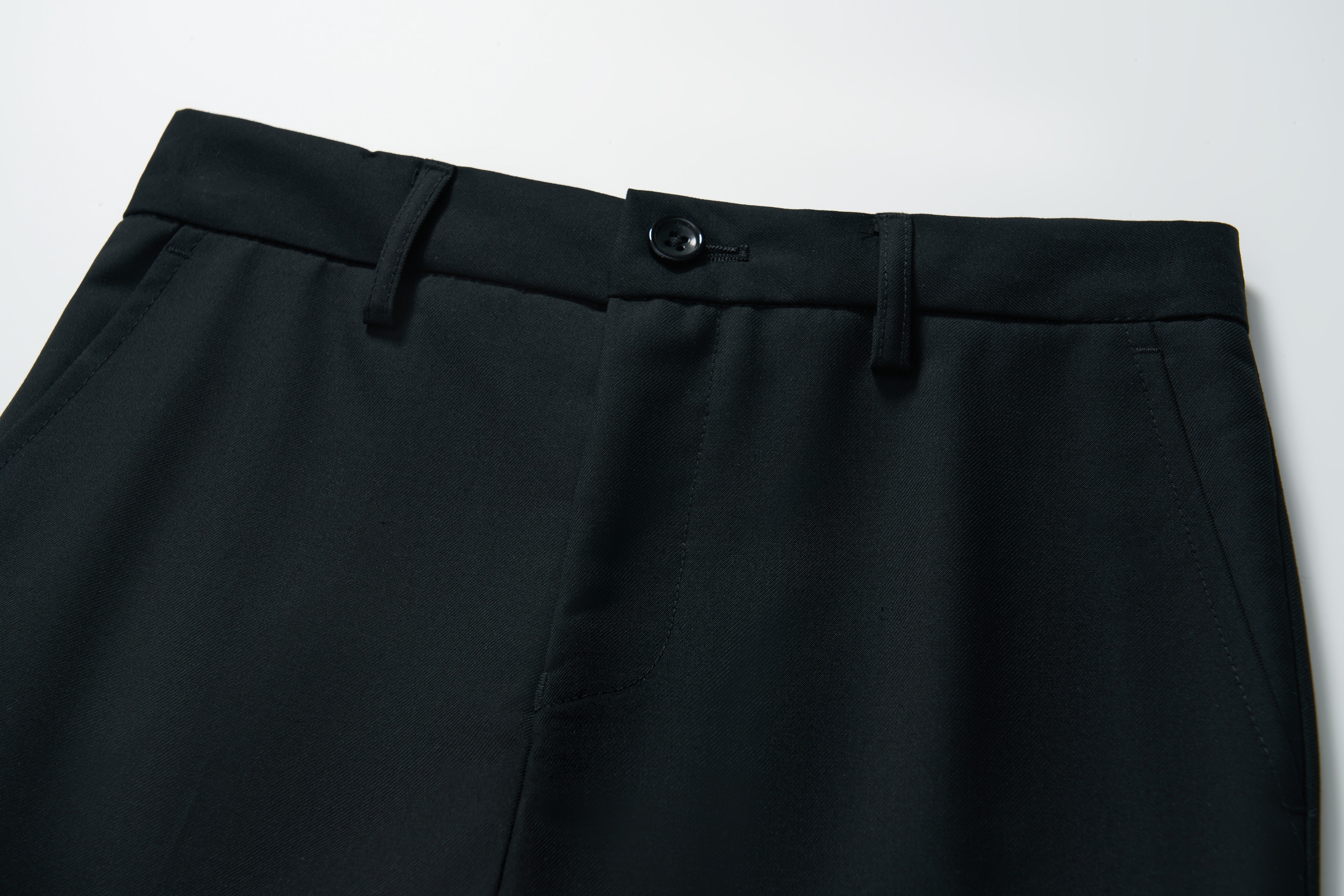 Close-up of the waistband and upper section of KIKI and JOJO's Noir Bloom Suit Pants for boys, featuring belt loops, button closure, and side pockets on a white background—ideal for formal occasions.