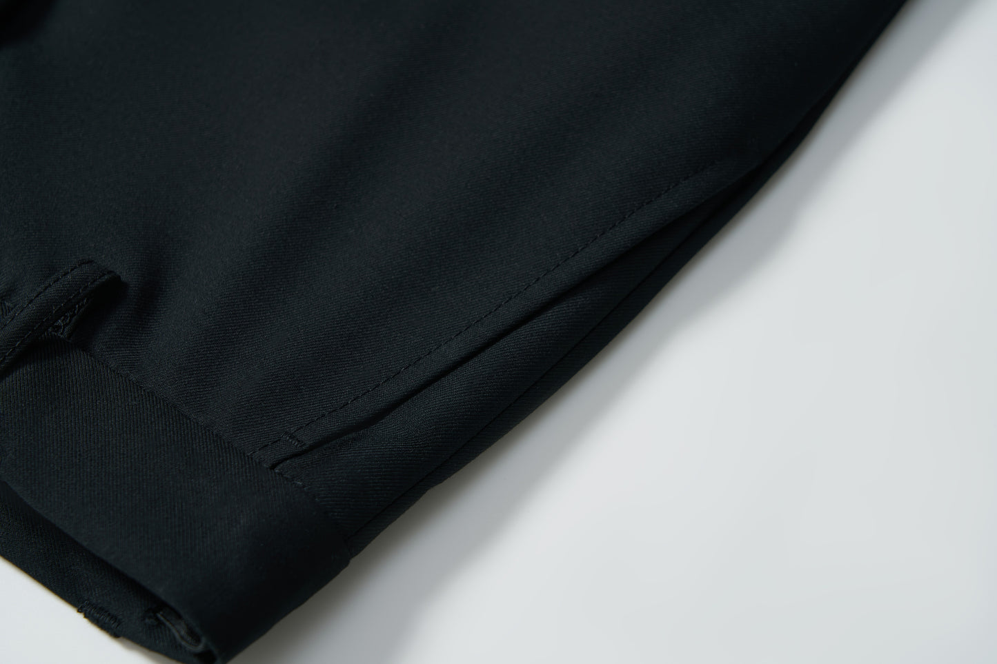 Close-up of the leg and pocket area of KIKI and JOJO Noir Bloom Suit Pants for boys, featuring a straight-leg cut in black—perfect for formal occasions.