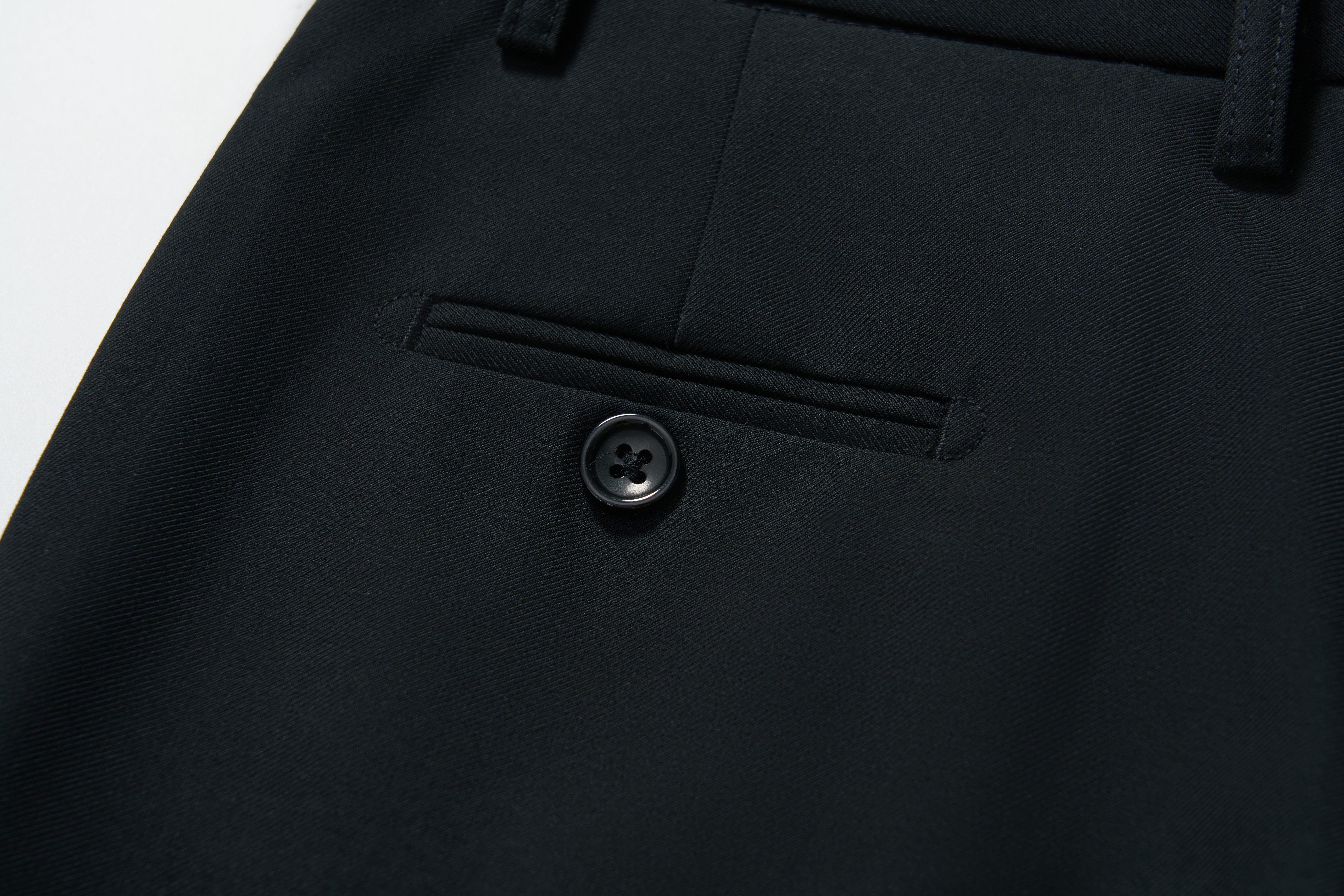 Close-up of KIKI and JOJO’s Noir Bloom Suit Pants for boys, featuring a straight-leg cut, tailored stitching, belt loops, and a black button—ideal for formal occasions.