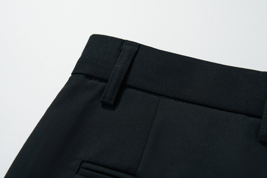 Close-up of the waistband and belt loop of KIKI and JOJO Noir Bloom Suit Pants for boys, showing a glimpse of the front pocket. Ideal for formal events. Displayed on a plain white background.