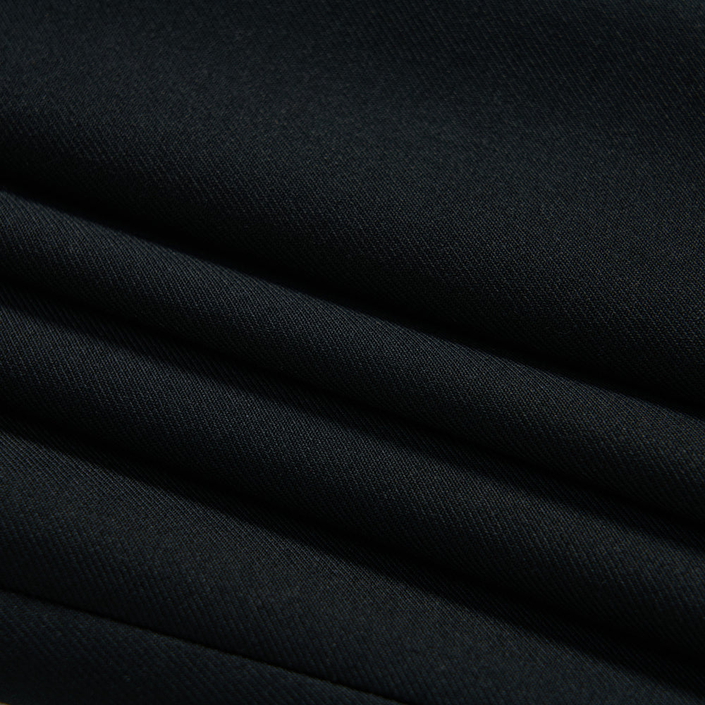 Close-up of several layers of neatly folded black fabric with a smooth, matte texture.