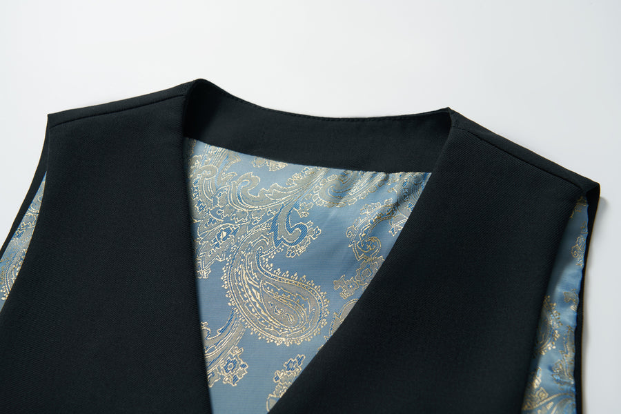 Close-up of the KIKI and JOJO Noir Bloom Suit Vest for boys, showcasing its blue and gold paisley-patterned inner lining—an elegant addition to any formal wardrobe. Displayed on a white background.