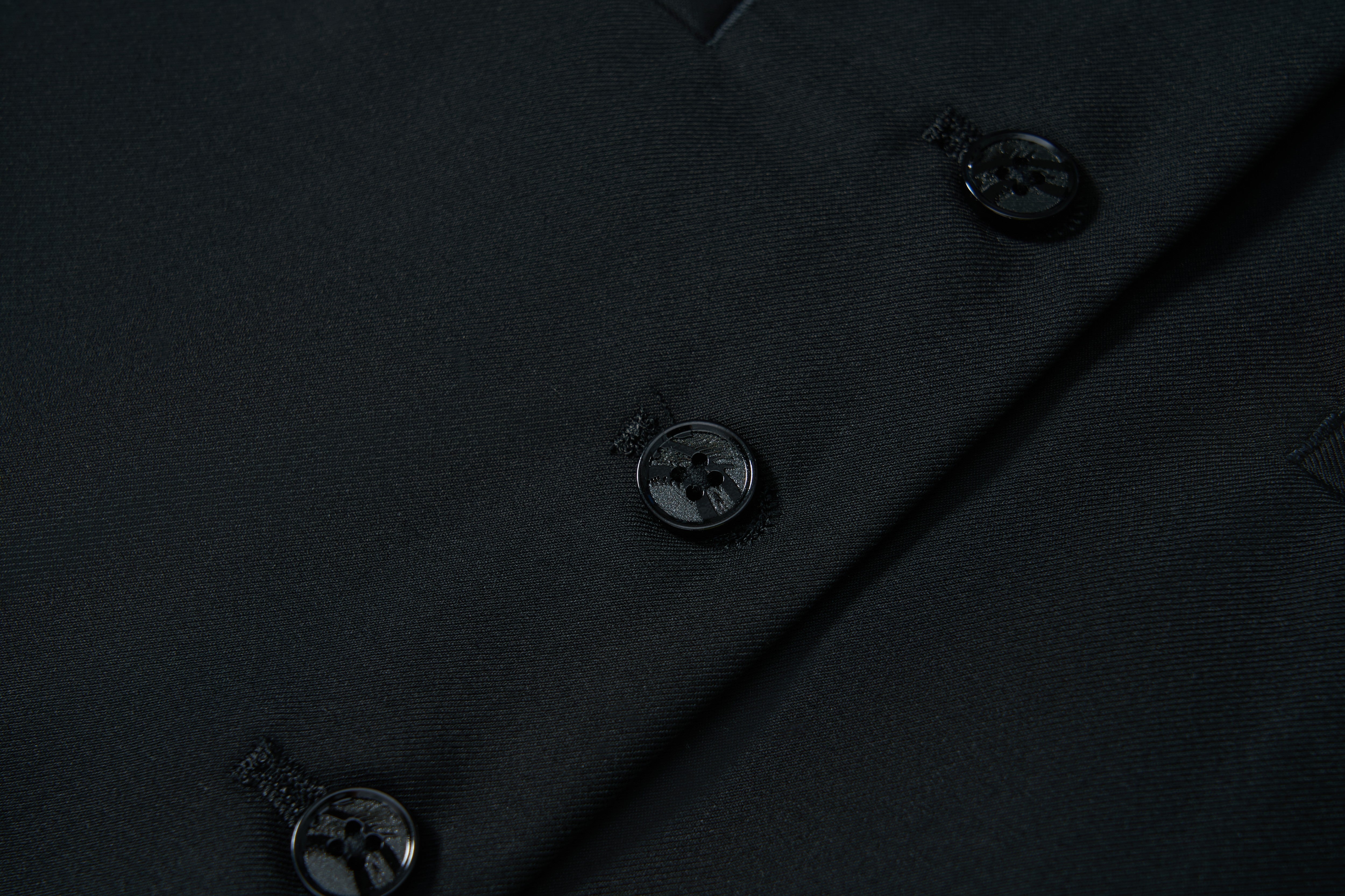 Close-up of the Noir Bloom Suit Vest by KIKI and JOJO in black, featuring three black sewn-on buttons with matching buttonholes—perfect for elevating any formal wardrobe.