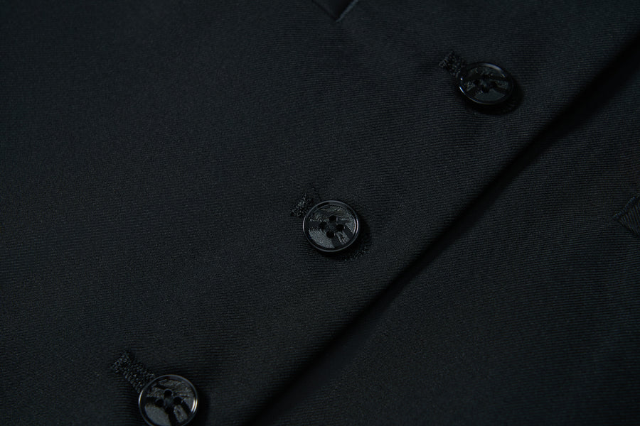 Close-up of the Noir Bloom Suit Vest by KIKI and JOJO in black, featuring three black sewn-on buttons with matching buttonholes—perfect for elevating any formal wardrobe.