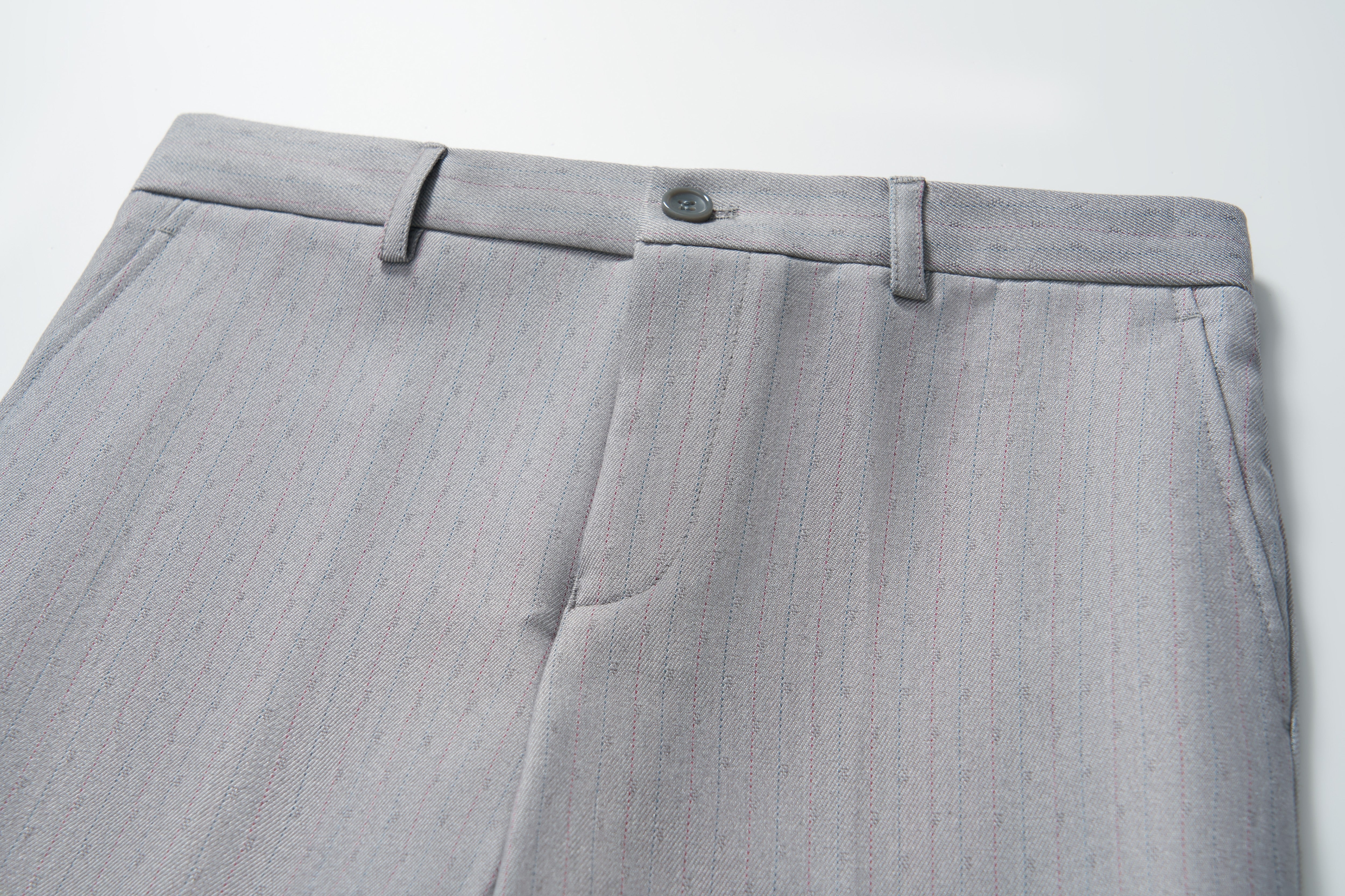 Close-up of KIKI and JOJO Silver Bloom Suit Pants for boys, featuring belt loops, button closure, subtle vertical pinstripes, and an adjustable waistband, shown on a white background.