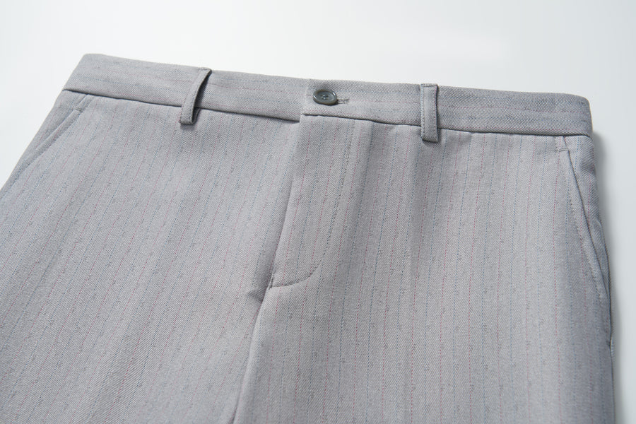 Close-up of KIKI and JOJO Silver Bloom Suit Pants for boys, featuring belt loops, button closure, subtle vertical pinstripes, and an adjustable waistband, shown on a white background.