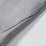 Close-up of KIKI and JOJO Silver Bloom Suit Pants for boys, featuring a gray pinstripe design, cuffed hem, adjustable waistband, and side pocket, laid flat on a white surface.