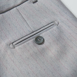 Close-up of the back pocket of KIKI and JOJO's Silver Bloom Suit Pants, showing a single-button horizontal welt pocket and an adjustable waistband for comfort.