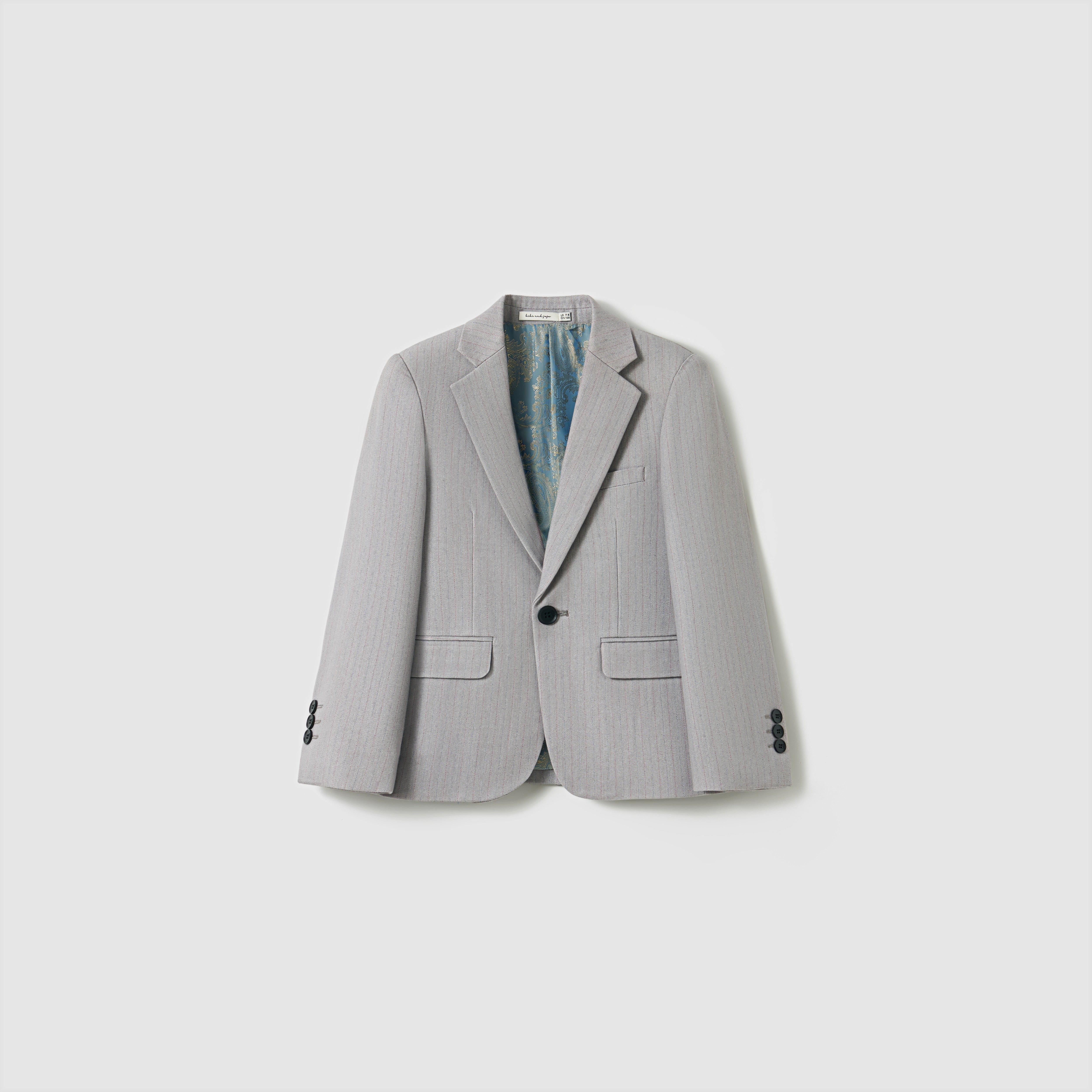 The KIKI and JOJO Silver Bloom Suit Jacket features light gray stripes, black buttons, two front pockets, and a chest pocket—ideal for boys’ formal wear. Displayed on a plain white background.