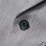 Close-up of the KIKI and JOJO Silver Bloom Suit Jacket in light gray with subtle stripes and a single black button by the lapel—ideal for formal boys’ attire.