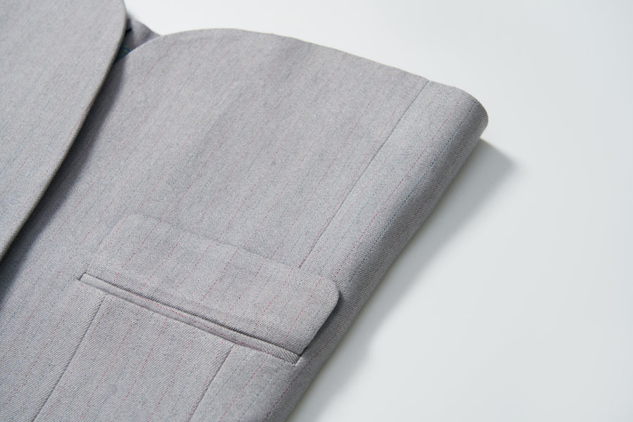 Close-up of the Silver Bloom Suit Jacket by KIKI and JOJO, featuring light gray stripes on the sleeve and pocket—ideal for boys’ formal attire against a white background.