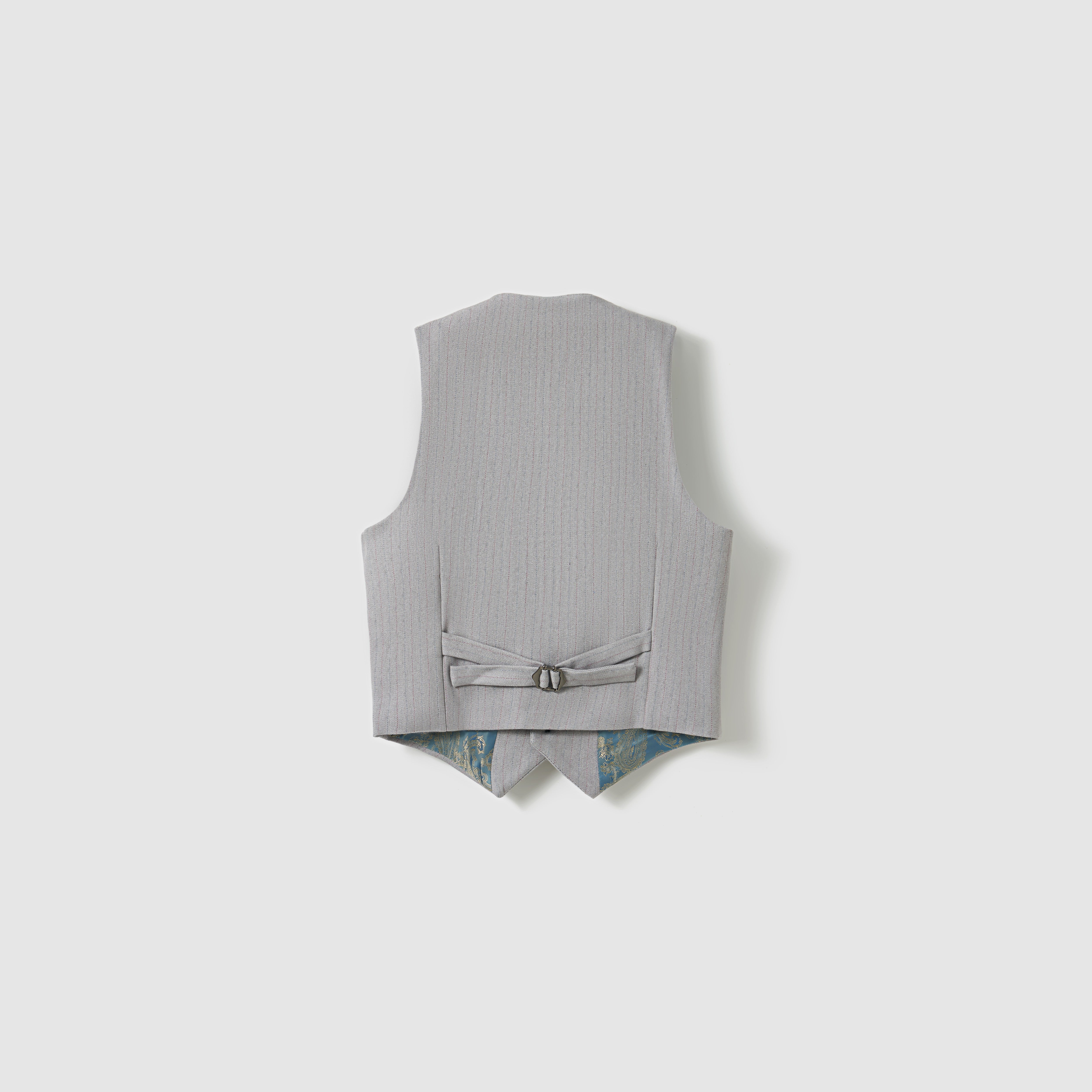 The KIKI and JOJO Silver Bloom Suit Vest is shown from the back, revealing an adjustable strap with buckle and a glimpse of its subtle patterned lining at the hem.