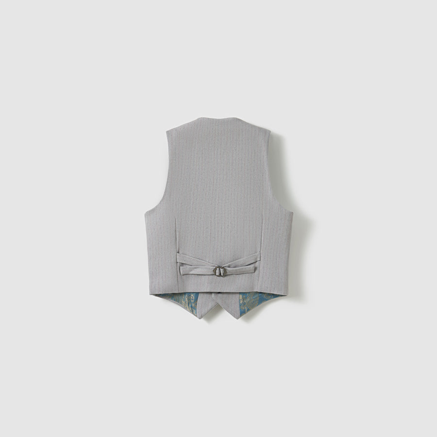 The KIKI and JOJO Silver Bloom Suit Vest is shown from the back, revealing an adjustable strap with buckle and a glimpse of its subtle patterned lining at the hem.