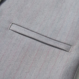 Close-up of a gray suit jacket with subtle pinstripes, welt pocket, and black button—ideal to pair with the KIKI and JOJO Silver Bloom Suit Vest for a refined look.