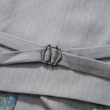 Close-up of an adjustable side strap with a metal buckle on the KIKI and JOJO Silver Bloom Suit Vest, showing part of patterned fabric underneath.