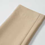 A close-up of the neatly folded hem on KIKI and JOJO Savoy Dune Suit Pants, showcasing the stitching and fabric texture against a plain white background.