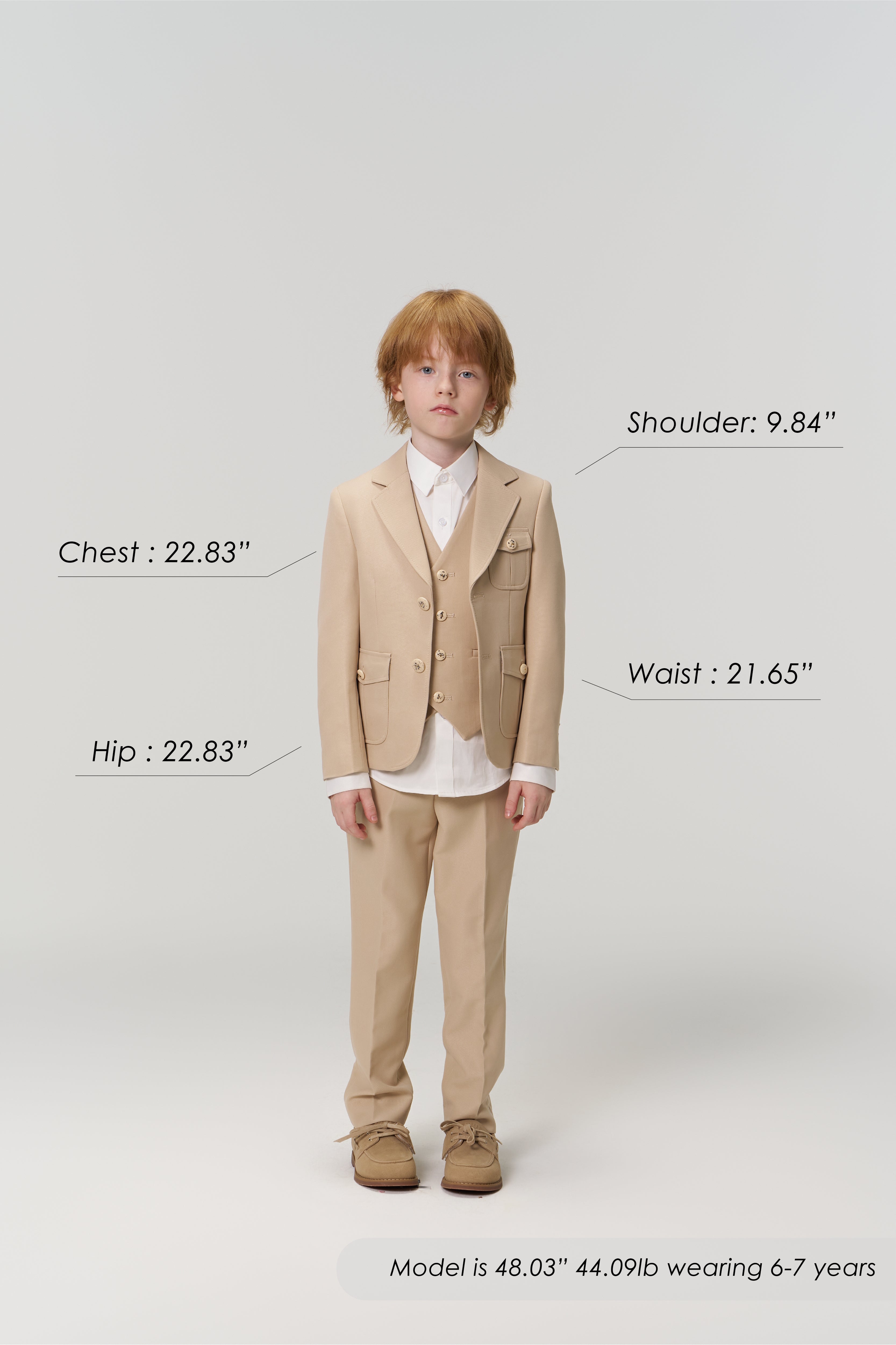 A young boy models the KIKI and JOJO Savoy Dune Suit Vest in khaki beige, facing forward with chest, hip, shoulder, and waist measurements labeled—ideal for special occasions. Model's height, weight, and age are shown below.