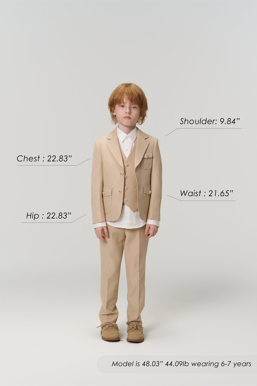 A young boy models the KIKI and JOJO Savoy Dune Suit Vest in khaki beige, facing forward with chest, hip, shoulder, and waist measurements labeled—ideal for special occasions. Model's height, weight, and age are shown below.