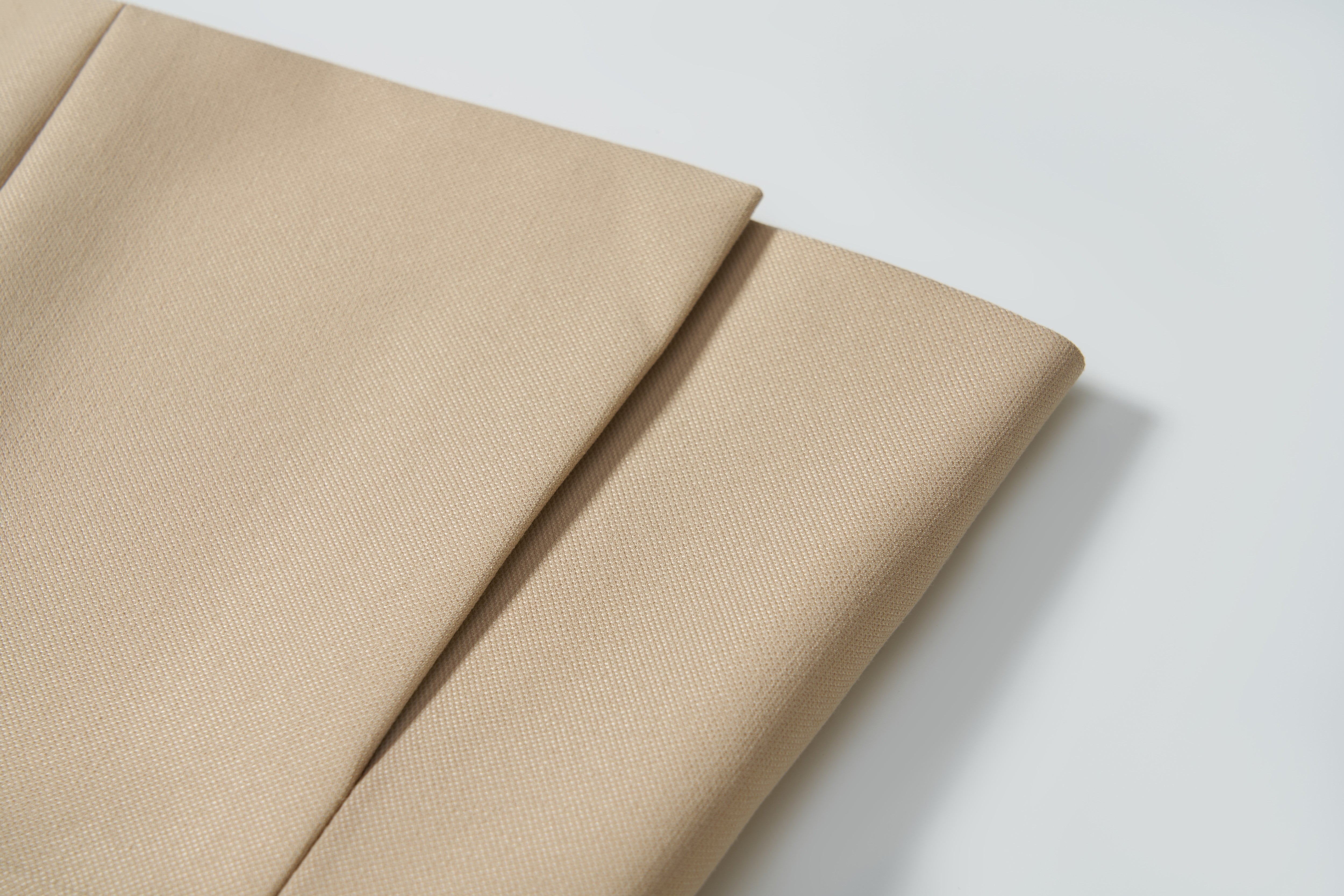 Close-up of Savoy Dune Suit Jacket fabric by KIKI and JOJO, featuring subtle beige texture—ideal for classic tailoring or crafting a khaki boys suit jacket for formal occasions.