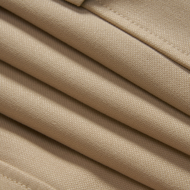 Close-up view of neatly folded beige fabric, showing the texture and stitching details.