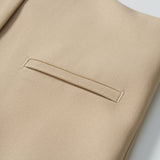 Close-up of the Savoy Dune Suit Vest by KIKI and JOJO, showcasing its smooth, textured fabric with a welt pocket and button—ideal for special occasions.