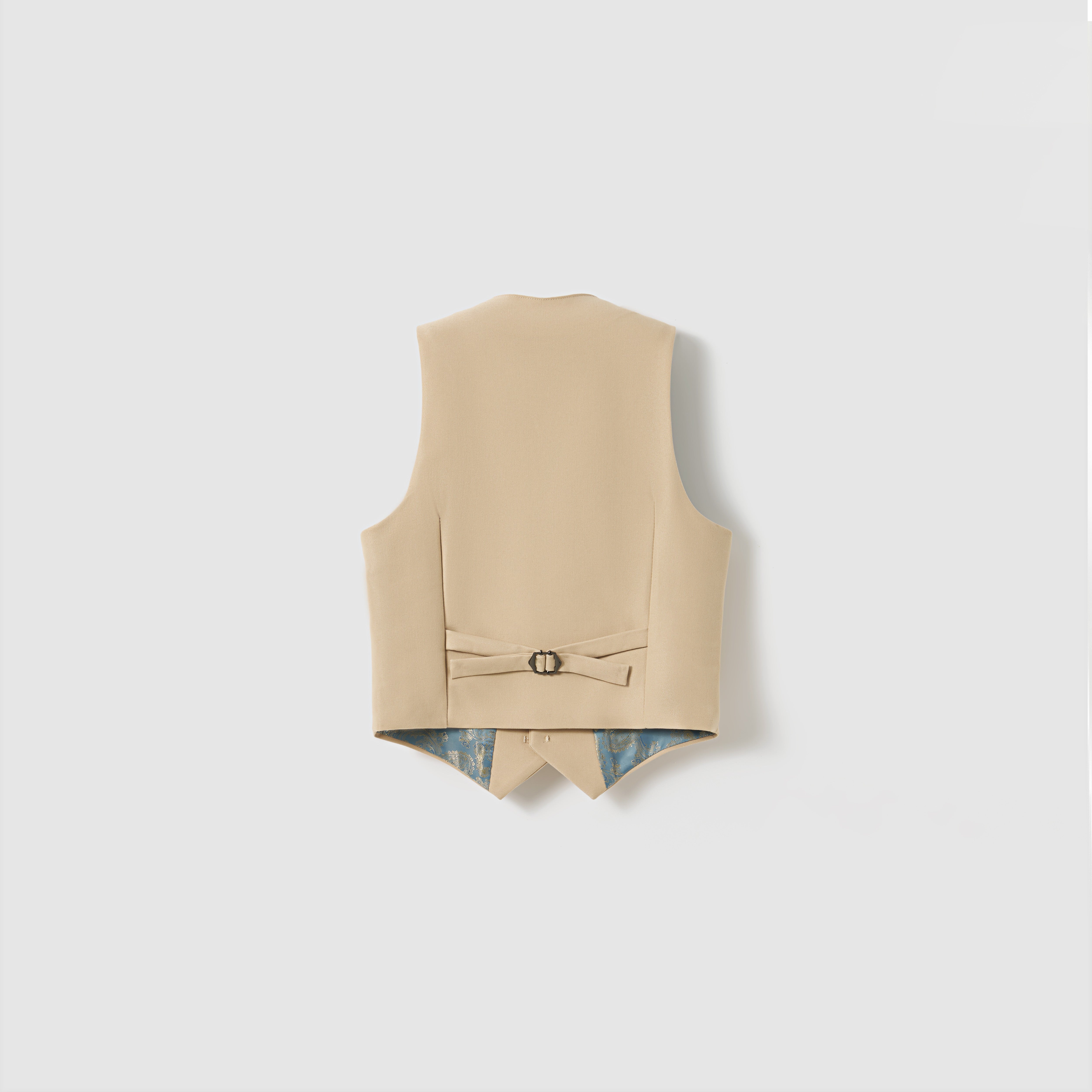 The KIKI and JOJO Savoy Dune Suit Vest is shown from the back, featuring an adjustable waist belt and buckle. Its khaki beige lining with a contrasting blue pattern peeks out at the bottom—ideal for any special occasion.