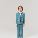 A young red-haired child faces forward, wearing the KIKI and JOJO Celeste Whimsy Suit Jacket with a bow tie and white shoes, set against a plain light background.