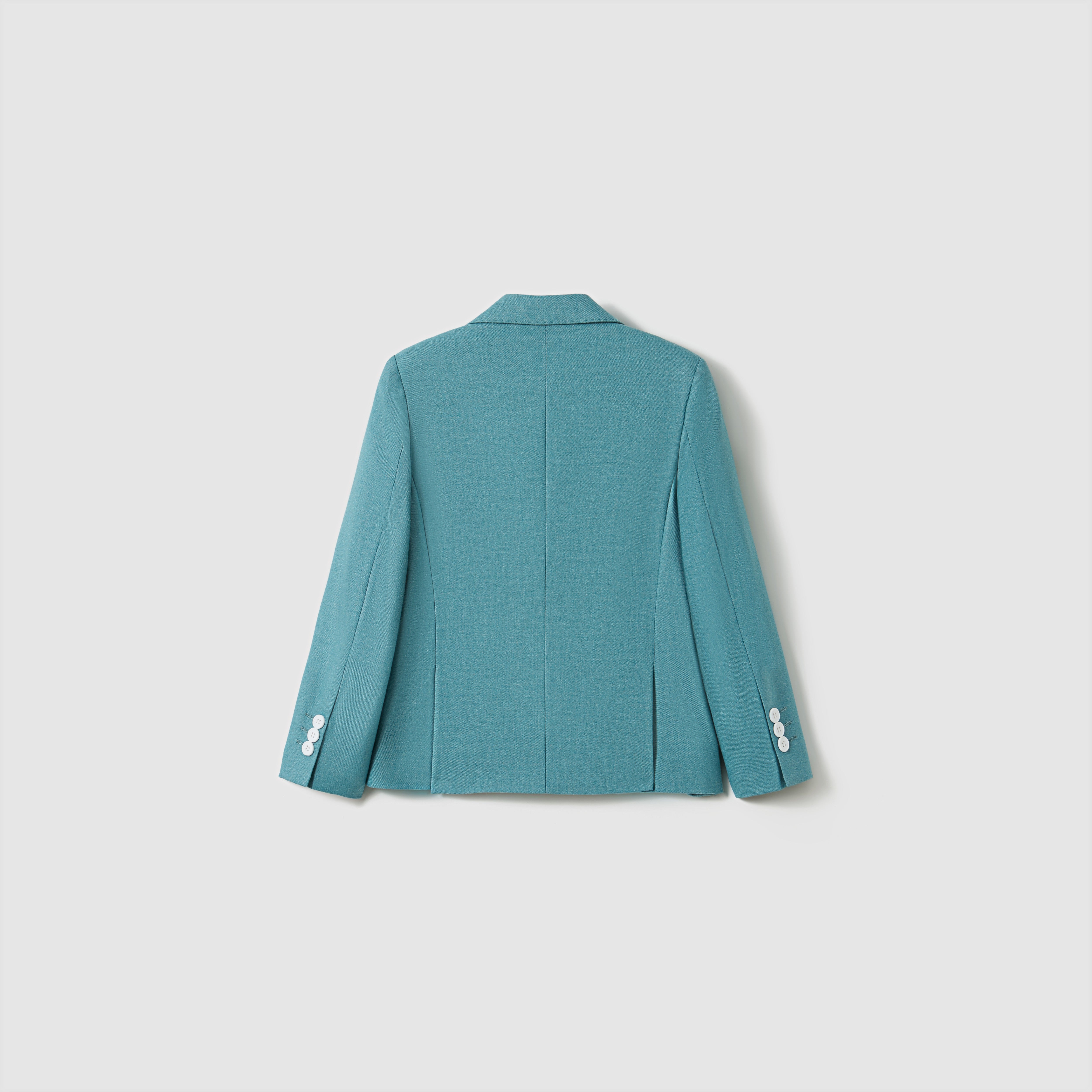 The Celeste Whimsy Suit Jacket by KIKI and JOJO is displayed from the back, showcasing a structured fit and white sleeve buttons against a simple light background.